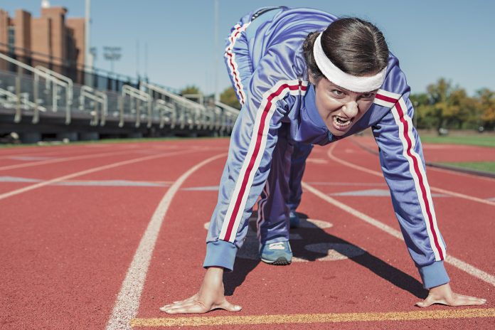 A person with an intense face getting ready to sprint in effort to test if intense exercise is better than moderate exercise for those living with type 2 diabetes.