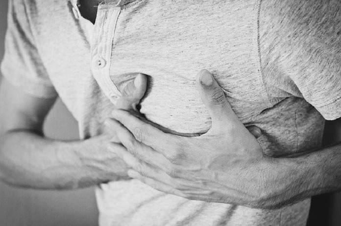 man holding chest