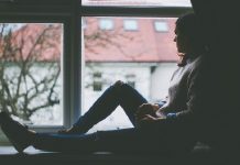 woman sitting at a window