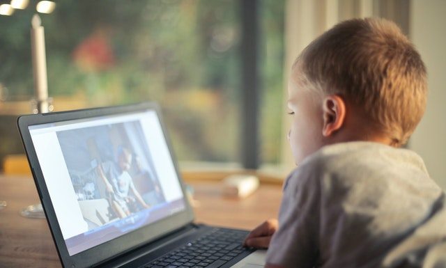 child watching video on computer screen