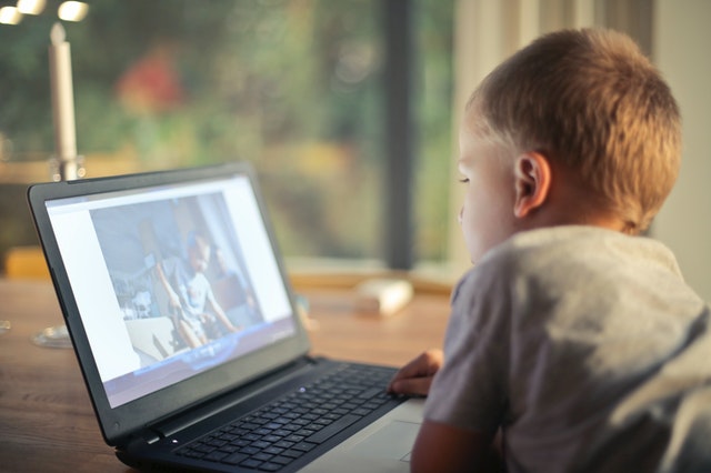 child watching video on computer screen