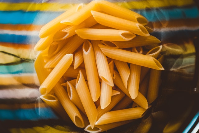 Uncooked pasta in a bowl is an example of a carbohydrate. Testing the nutritional value of carbohydrates is important as this macronutrient affects many bodily processes.