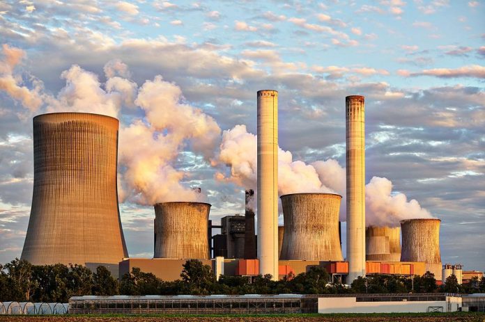 A power plant emitting fumes causing air pollution affecting human health.