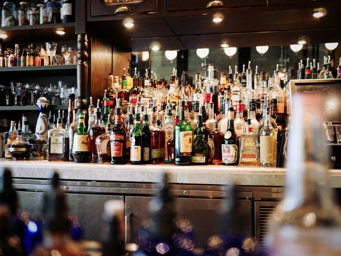 A bar counter filled with alcoholic drinks not meeting the new Canadian alcohol consumption guidelines.