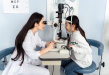 A young girl with an optometrist
