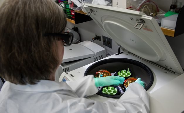 A scientist working in a lab to bring new drug approvals from clinical trials to the pharmacy.