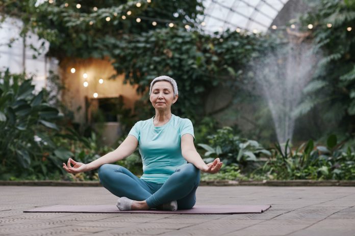 An image of a woman practicing mindfulness meditation to improve cognitive function.