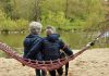 Two women sitting on a hammock sharing stories about menopause symptoms and their menopause treatment options,