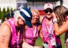 A group of women wearing the breast cancer ribbon to celebrate one woman's survival after overcoming aggressive breast cancer.