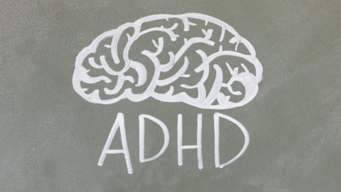 Chalk drawing on a blackboard of a brain, accompanied by the acronym ADHD.
