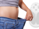 Photo of a person stretching his pants to waist height, highlighting his/her weight loss.